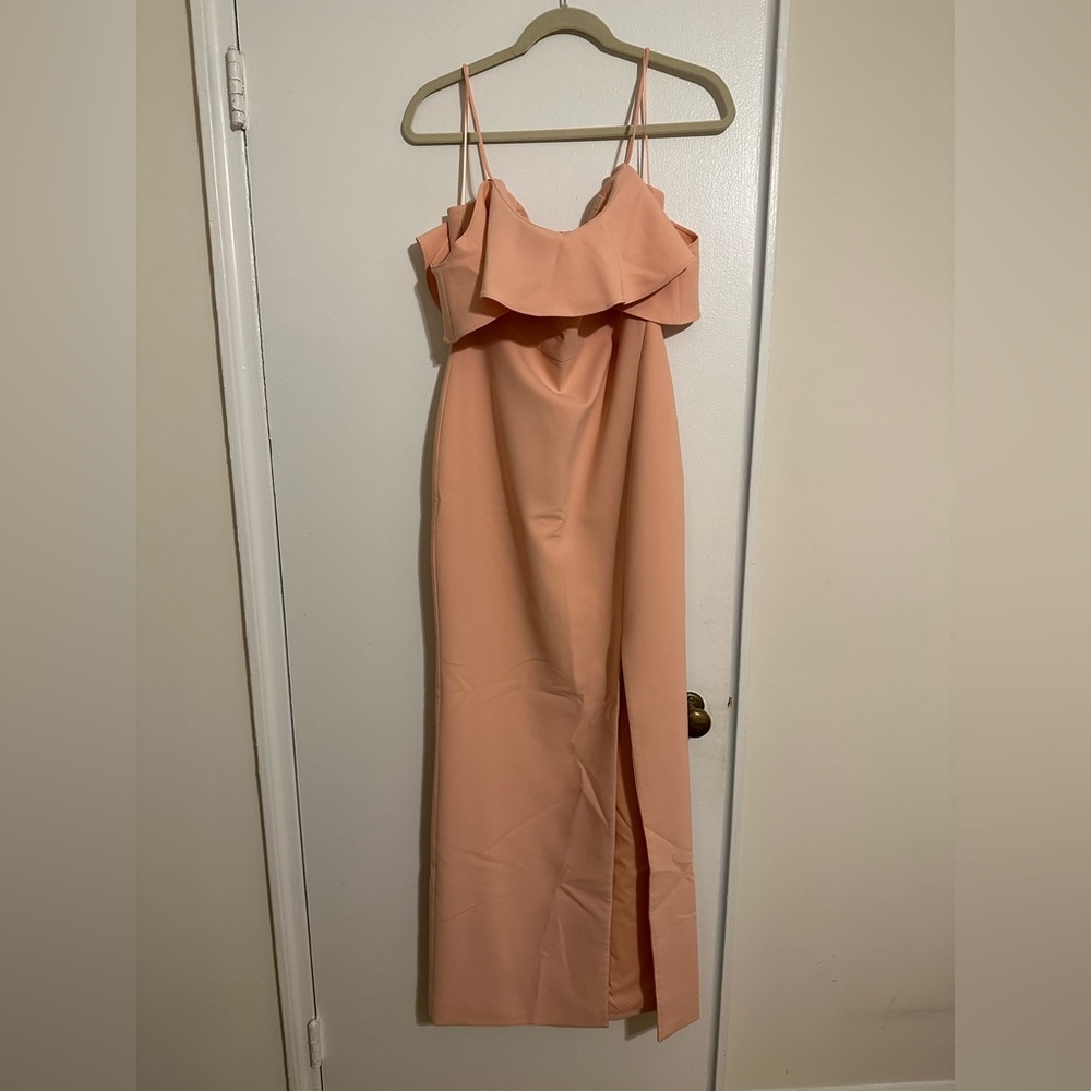 Likely peach long gown with slit and ruffles